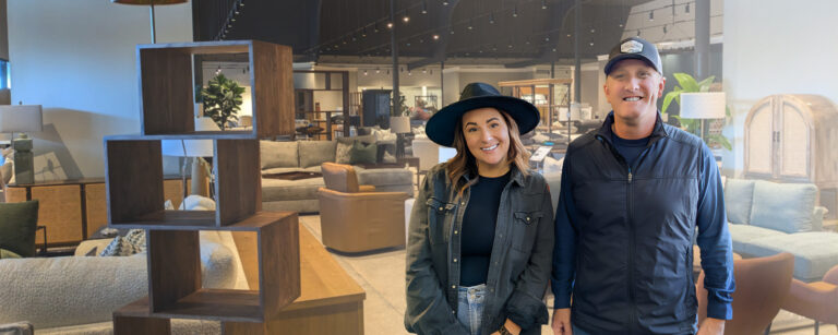 Two people standing in a furniture store